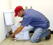 Plumber fixing toilet